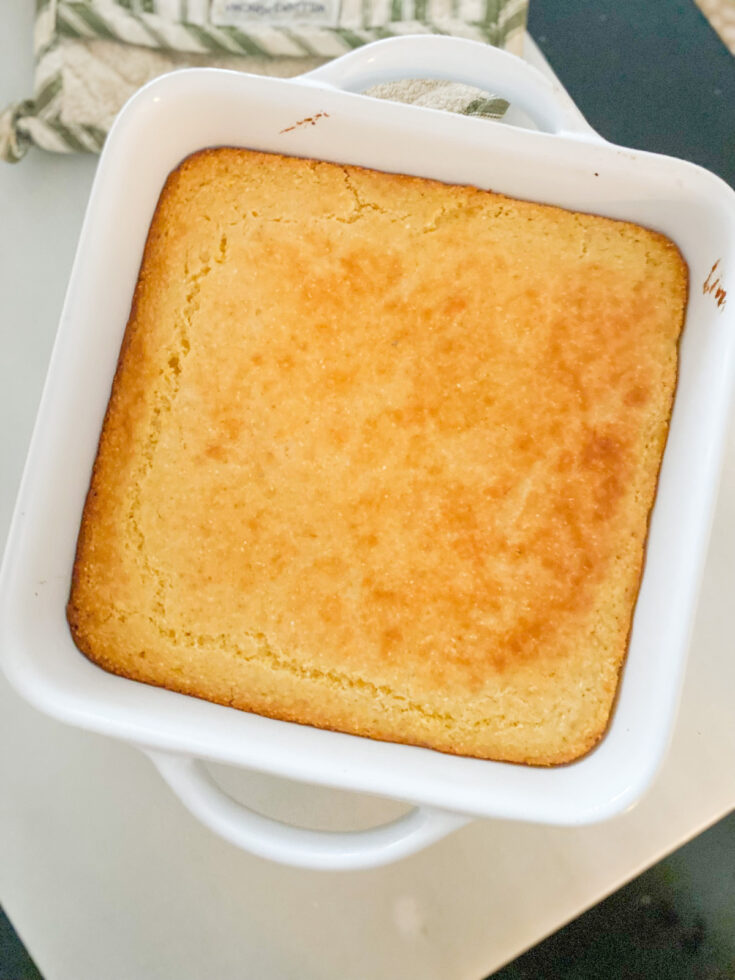 large white square baking dish filled with golden brown sourdough cornbread