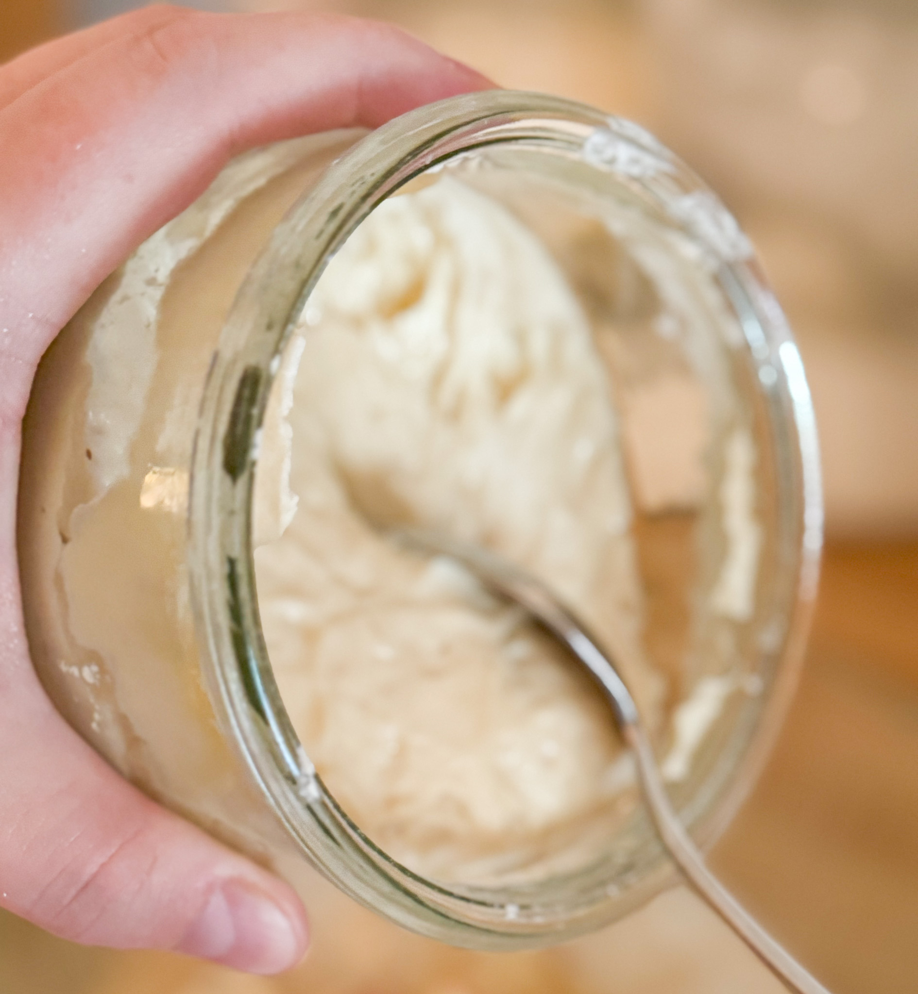 sourdough starter in a glass jar with spoon